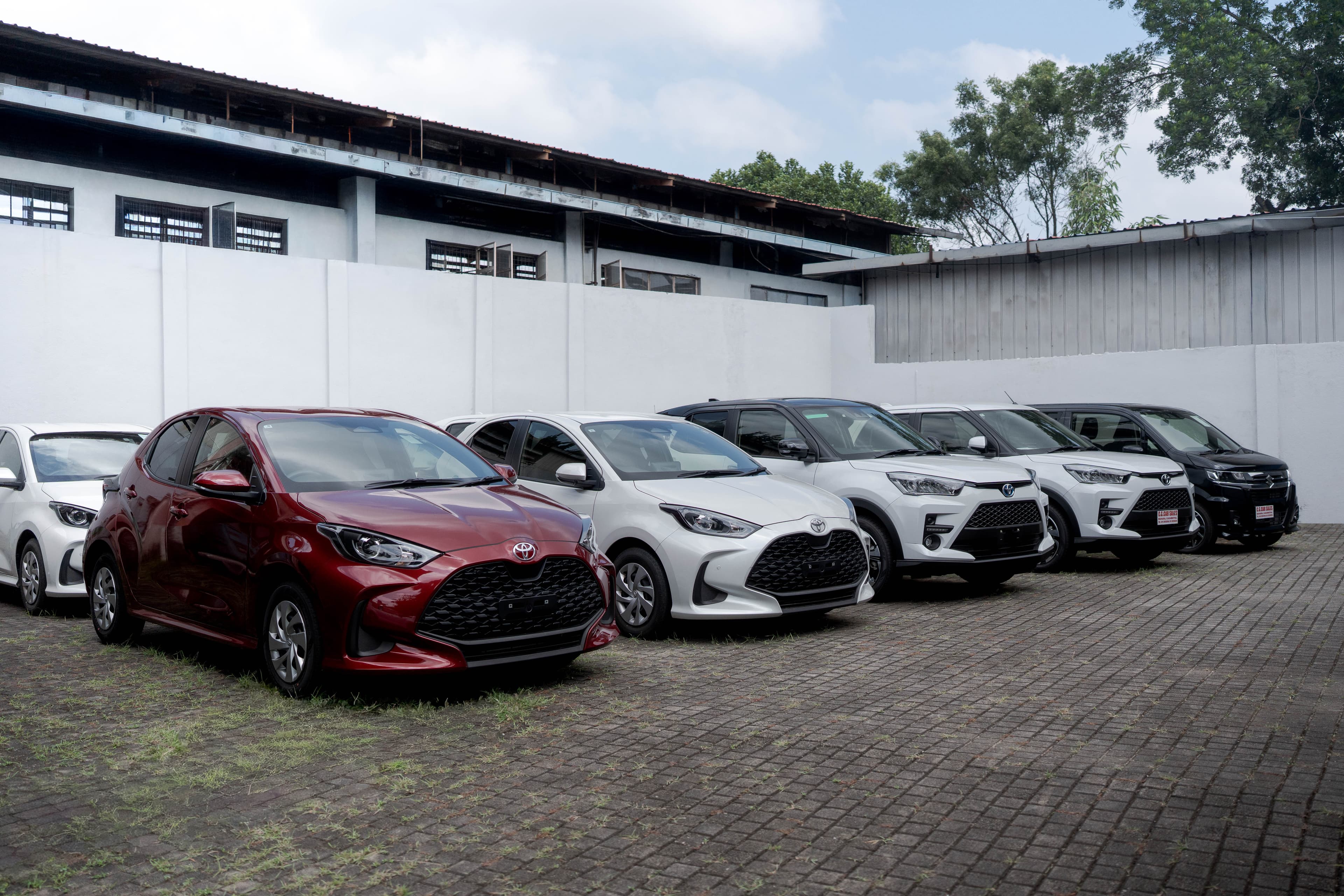Row of hatchbacks and SUVs parked in the C.S. Car Sales yard